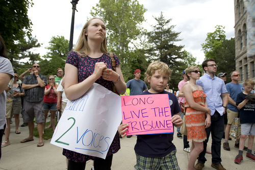 Melissa Majchrzak  |  Special to the Tribune
Emily and Giovanni Nuvan hold signs in support of the Tribune at the "Save the Tribune" rally, held at the City and County Building on May 31, 2014.