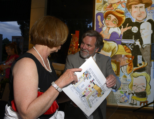 Scott Sommerdorf  |  The Salt Lake Tribune

Pat Bagley signs a cartoon for Pam Krieps during a reception "An Evening With Pulitzer Finalist, Pat Bagley" at the Leonardo, celebrating 35 years of political cartoons, Saturday, May 31, 2014