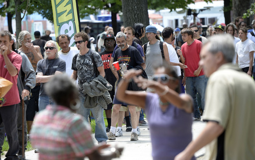 Al Hartmann  |  The Salt Lake Tribune
People dance to a radio dj's music and others wait in line to get free Subway sandwiches, fruit, and drinks at Pioneer Park Wednesday May 28.  Subway partnered with the Resuce Mission of Salt Lake for the annual "Day of Giving" with free Subway sandwiches, clothes and giveaways for low income and homeless people.   Subway also presented a $10,000 check to the Rescue Mission of Salt Lake.