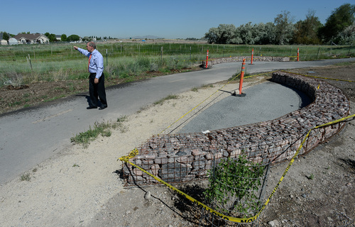 Francisco Kjolseth  |  The Salt Lake Tribune
Rick Graham, public works director for Salt Lake City points out the area mitigated for wetlands alongside what will soon be the Salt Lake City soccer complex near the Jordan River in North Salt Lake where the underlying infrastructure has been laid. By August of 2015 the 160 acres should be fully transformed into 15 multi-use fields primarily used for soccer and one stadium field.