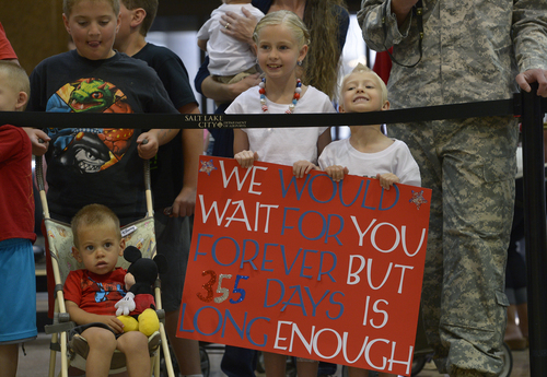 Scott Sommerdorf   |  The Salt Lake Tribune
Children wait for their father to return as about 18 Utah National Guard soldiers returned home Saturday from a 12-month deployment to Afghanistan. Members of the Guard's 65th Field Artillery Brigade were greeted by their loved ones at Salt Lake City International Airport, Saturday, May 31, 2014.
