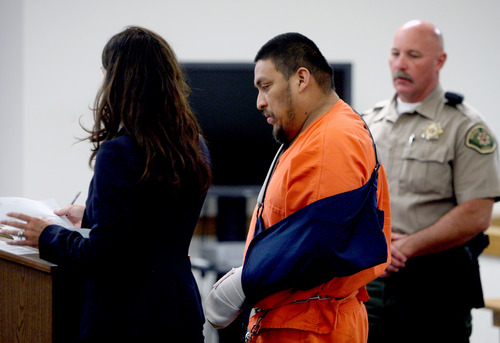Elvis Quintanilla-Vasquez, right, stands with defense attorney Cara Tangaro during his initial court appearance Tuesday, June 3, 2014, in Moab's 7th District Court. Quintanilla-Vasquez is charged with four counts of aggravated human smuggling, three counts of human smuggling, one count of improper lane travel in connection with a May 16, 2014, crash on I-70 in Grand County that killed four people and injured four others.