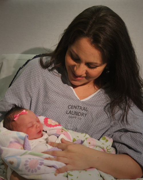 Rick Egan  |  Tribune file photo 
Monica  Rossano holds newborn Anna-Sofia Rossano -- Utah's first baby of 2013 -- at Intermountain Medical Center in Murray. Anna-Sofia, born at 12:01 a.m. on New Year's Day in 2013, led another year of declining births in Utah, according to new data from the Centers for Disease Control and Prevention.
