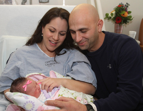 Rick Egan  | Tribune file photo 
Monica and Salvatore Rossano hold newborn Anna-Sofia Rossano -- Utah's first baby of 2013 -- at Intermountain Medical Center in Murray. Anna-Sofia, born at 12:01 a.m. on New Year's Day in 2013, led another year of declining births in Utah, according to new data from the Centers for Disease Control and Prevention.