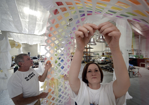 Al Hartmann  |  The Salt Lake Tribune
Designer-builders Chris Johnson and Jolene Mewing with the Utah Pride Center put finishing touches on a rainbow wedding arch complete with silver bells for their marriage celebration float for the 2014 Utah Pride Parade next weekend. When finished, the float will hold about 50 couples recently married after the state's ban on gay marriage was overturned in December. One logistical problem has been constructing a float large enough for as many couples as possible.