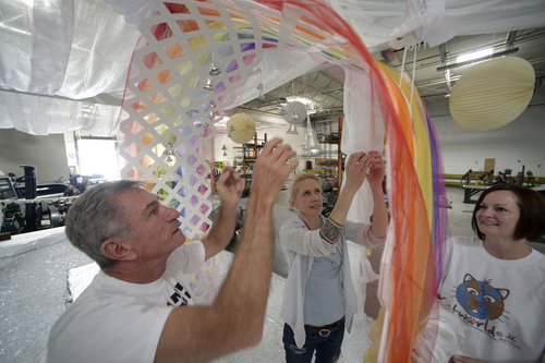 Al Hartmann  |  The Salt Lake Tribune
Designer-builders Chris Johnson, Monique Lanier, and Jolene Mewing with the Utah Pride Center put finishing touches on a rainbow wedding arch for their marriage celebration float for the 2014 Utah Pride Parade next weekend. When finished, the float will hold about 50 couples recently married after the state's ban on gay marriage was overturned in December. One logistical problem has been constructing a float large enough for as many couples as possible.