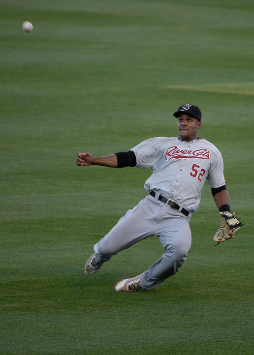 Francisco Kjolseth  |  The Salt Lake Tribune
Michael Taylor of the Sacramento River Cats slides in for a catch but comes up short against the Salt Lake Bees at Smith's Ballpark on Thursday, June 5, 2014.