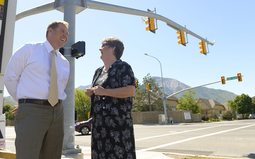 Leah Hogsten  |  The Salt Lake Tribune
Utah Department of Transportation Region 2 Director Nathan Le, left, chats with East Millcreek Community Council Chairwoman Nancy Carlson-Gotts  near a pedestrian signal at 2940 E. 3300 South. A press conference about the semaphore kicked off a campaign for road safety efforts in Salt Lake County's unincorporated areas, Thursday, June 5, 2014.