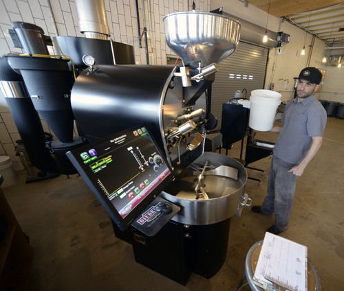 Al Hartmann  |  The Salt Lake Tribune
Head roaster Ryan Gee gets set to roast a batch of coffee beans in the computerized roaster at  Publik Coffee Roasters at 975 S. West Temple.  The refurbished building used to be a print shop. Beans from around the world are shipped in and roasted in a high-tech computerized roaster. It's a two-story building and one can look down on the main floor from the upper seating area that has Wi-Fi and meeting rooms. The menu is all toast using Utah-made bread with different toppings: from butter and jam to avocado.