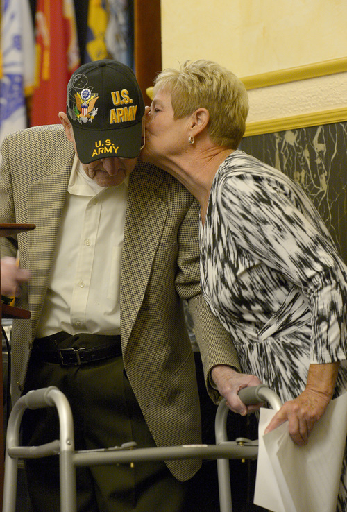 Leah Hogsten  |  The Salt Lake Tribune
Pam Hutchinson kisses her father Albert Vise, an Army D-Day veteran who stormed Omaha Beach after he shared his story of the invasion on the French coast, Friday, June 6, 2014. On the 70th Anniversary of D-Day, Fort Douglas Military Museum commemorated the Normandy invasion with a color guard and a salute to the troops, sailors and pilots who helped liberate France.