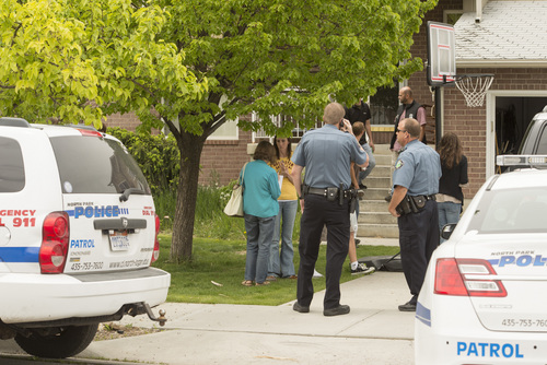 Rick Egan  |  The Salt Lake Tribune

North Park Police and ATF officers stand outside the Jason Burr's house in North Logan on May 16, 2014. Burr is the suspect in a shooting at the Cache Valley Hospital in Logan.