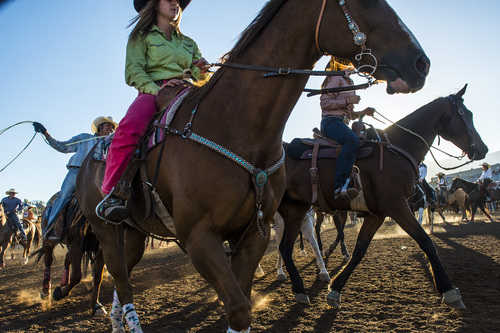 Chris Detrick  |  The Salt Lake Tribune
Cowboys and cowgirls ride around in the warmup arena during the Utah State High School Rodeo Association Finals at the Wasatch County Event Center in Heber City Thursday June 5, 2014.