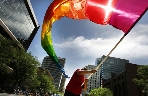 Scott Sommerdorf  |  The Salt Lake Tribune             
The 2014 Gay Pride Festival is this weekend with the parade June 8. In this 2012 photo, Randy Myers waves a huge rainbow flag near the end of the annual Gay Pride Parade through downtown Salt Lake City.