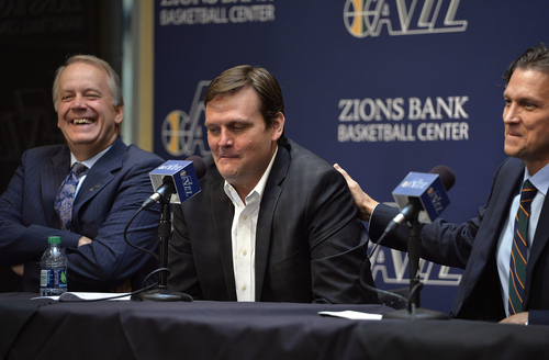 Scott Sommerdorf   |  The Salt Lake Tribune
New Jazz coach Quin Snyder, right, playfully pats GM Dennis Lindsey on his shoulder as he teases Lindsey about his assessment of him as a coach early in his career. At left laughing, is Jazz President Randy Rigby. The Utah Jazz introduced Quin Snyder as their new head coach, Saturday, June 7, 2014.