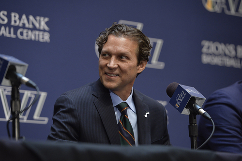 Scott Sommerdorf   |  The Salt Lake Tribune
Quin Snyder flashes a grin as Jazz GM Dennis Lindsey talks baout the hiring process. The Utah Jazz introduced Quin Snyder as their new head coach, Saturday, June 7, 2014.