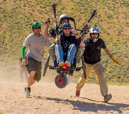 Trent Nelson  |  The Salt Lake Tribune
Iraq War veteran Gordon Ewell takes off while paragliding as part of "Wings of Inspiration", an even created by Mike Semanoff to allow wounded and disable veterans to experience the thrill of flight, at the Point of the Mountain in Draper, Saturday June 7, 2014. Mark Rich, left, and Sam Sanderson give him a helpful push.