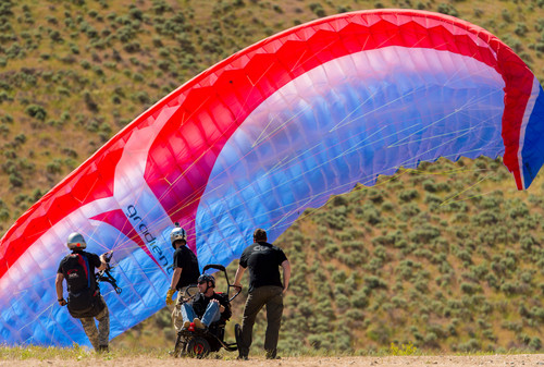 Trent Nelson  |  The Salt Lake Tribune
Iraq War veteran Gordon Ewell prepares for take off, paragliding as part of "Wings of Inspiration", an even created by Mike Semanoff to allow wounded and disable veterans to experience the thrill of flight, at the Point of the Mountain in Draper, Saturday June 7, 2014.