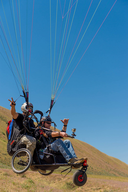 Trent Nelson  |  The Salt Lake Tribune
Mike Semanoff and Gordon Ewell take off while paragliding as part of "Wings of Inspiration," an even created by Semanoff to allow wounded and disable veterans to experience the thrill of flight, at the Point of the Mountain in Draper on Saturday.