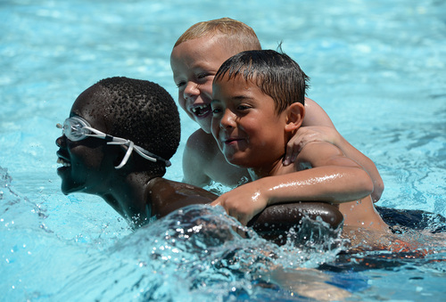 Francisco Kjolseth  |  The Salt Lake Tribune
Friends Bapdiet Bol, 9, Corbin Aguilar, 7, and Thomas Hoppe, 7, from left, play at the Redwood Recreation Center in West Valley City on Tuesday, June 10, 2014. The Salt Lake County Health Department held its annual healthy swimming season media kickoff to remind residents to practice healthy swimming behaviors, especially implementing good hygiene habits and not visiting the pool while ill with diarrhea.