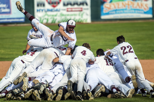 Chris Detrick  |  The Salt Lake Tribune
Jordan's Mason Krueger jumps onto the dog pile with other members of the Jordan baseball team as they celebrate winning the 5A state championship at Brent Brown Ballpark Friday May 23, 2014. Jordan defeated Pleasant Grove  4-3.