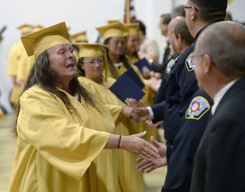 Al Hartmann  |  The Salt Lake Tribune
Inmates shake hands and get congratulations upon receiving diplomas during a graduation excercise at the Utah State Prison in Draper Wednesday June 11, 2014.  Two hundred seventy-three male and female inmates received their high school diplomas.