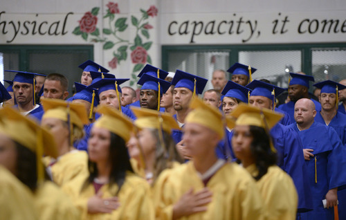Al Hartmann  |  The Salt Lake Tribune
Inmates stand for the American flag during a graduation excercise at the Utah State Prison in Draper Wednesday June 11, 2014.  Two hundred seventy-three male and female inmates received their high school diplomas.