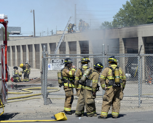Al Hartmann  |  The Salt Lake Tribune
Murray Fire and Unified Fire departments respond to a suspicious fire in a storage unit building at 4000 South and West Temple Wednesday June 11, 2014.  About six storage units were burned.