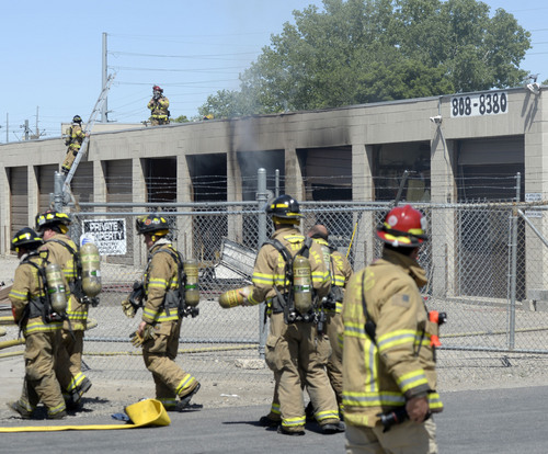 Al Hartmann  |  The Salt Lake Tribune
Murray Fire and Unified Fire departments respond to a suspicious fire in a storage unit building at 4000 South and West Temple Wednesday June 11, 2014.  About six storage units were burned.