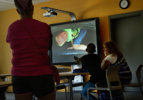 Scott Sommerdorf   |  The Salt Lake Tribune
Visitors watch a slide show in the library during a tour of the new Mountain Springs Pediatric Treatment Center, Thursday, June 12, 2014.