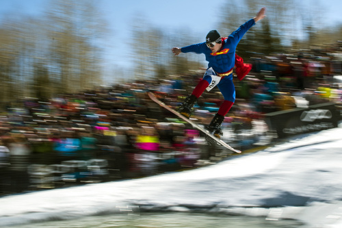 Chris Detrick  |  The Salt Lake Tribune
TJ Herron 'Superman' competes in the pond skimming contest during the 7th annual Spring Grüv at Canyons Resort Saturday March 22, 2014. Contestants were required to dress in costumes as they attempted to cross a 100-foot pond on skis or a snowboard.