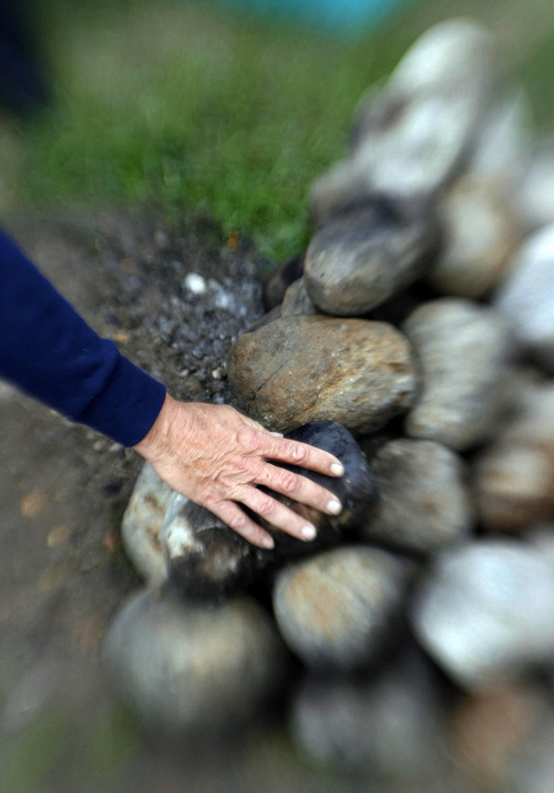 A volunteer and recovering drug addict at the VA Hopsital pulls cold stones from the sweat lodge erected in one of the hospital's court yards prior to another ceremonial sweat on Oct. 19, 2006.    Photo by Francisco Kjolseth/The Salt Lake Tribune