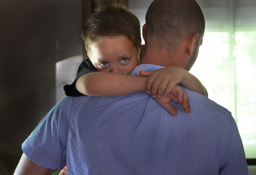 Scott Sommerdorf   |  The Salt Lake Tribune
Five year old Jesse Milner-Barraza is carried by one of his his Dads - Tony Milner - after Jesse came home from school, Friday, June 13, 2014.