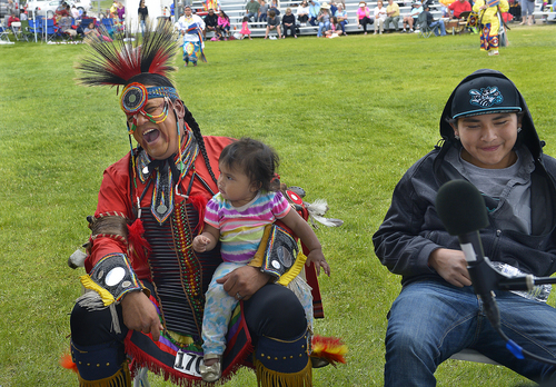 Scott Sommerdorf   |  The Salt Lake Tribune
Jesse Eagle Speaker laughs while holding his 1-year-old daughter Suzy as he waits with the rest of the "Silent Hill" singers for their turn to sing at the Heber Valley Pow-Wow at Soldier Hollow, Sunday, June 15, 2014.