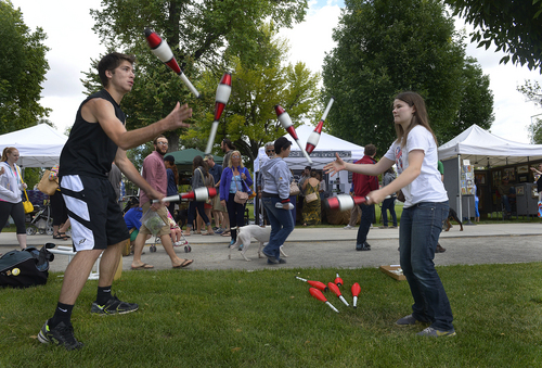 Scott Sommerdorf   |  The Salt Lake Tribune
Mather Reeves, left, and Delaney Bayless juggle at the opening day of the 2014 Downtown Farmers Market at Pioneer Park, Saturday, June 14, 2014.