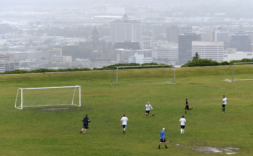 Al Hartmann  |  The Salt Lake Tribune
Die-hard soccer players workout in the rain at 11th Avenue Park above Salt Lake City shrouded in clouds Tuesday June 17.