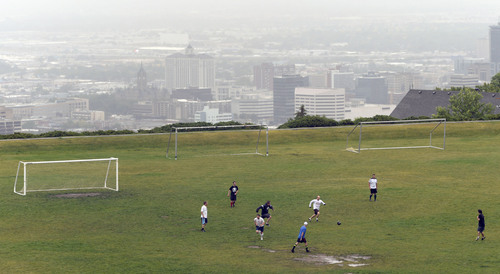 Al Hartmann  |  The Salt Lake Tribune
Die-hard soccer players workout in the rain at 11th Avenue Park above Salt Lake City shrouded in clouds Tuesday June 17.