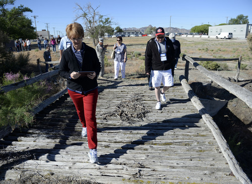Al Hartmann  |  The Salt Lake Tribune
Members of the Lincoln Highway Association walk one of the last original wooden bridges on the highway which still stands on Dugway Proving Grounds.  A group of about 100 visited the site Wednesday June 18.