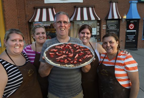 Scott Sommerdorf   |  The Salt Lake Tribune
The Drogueti family - outside the Sweet Spot Bakery and Cafeposes with a dessert pizza with chocolate and strawberies. From left to right: Graziela, Perola, Renaldo, Daniela and Vera Drogueti.