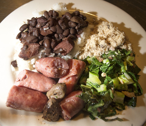 Steve Griffin  |  The Salt Lake Tribune

A plate of Feijoada, the national dish of Brazil, was served at Rodizio Grill in Salt Lake City, Utah Thursday, June 12, 2014. Feijoada is a stew made with black beans and pork and served over rice. Included on the plate is sausage,collard greens, chicken hearts and ground yuca.