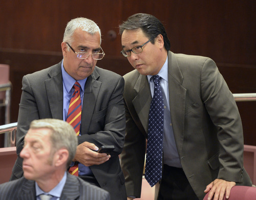 Al Hartmann  |  The Salt Lake Tribune
Salt Lake County District Attorney Sim Gill, left, confers with Criminal Division Chiefs Blake Nakamura, right, and Jeff Hall, front, before a press conference to announce a manslaughter charge filed against a former West Valley City police detective in the 2012 shooting death of 21-year-old Danielle Willard