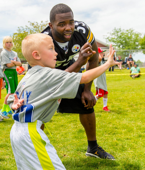 Trent Nelson  |  The Salt Lake Tribune
Pittsburgh Steeler Stevenson Sylvester runs drills with youth as retired and current NFL players stage a training session as part of the NFL Play 60 program, in Layton, Friday June 20, 2014.