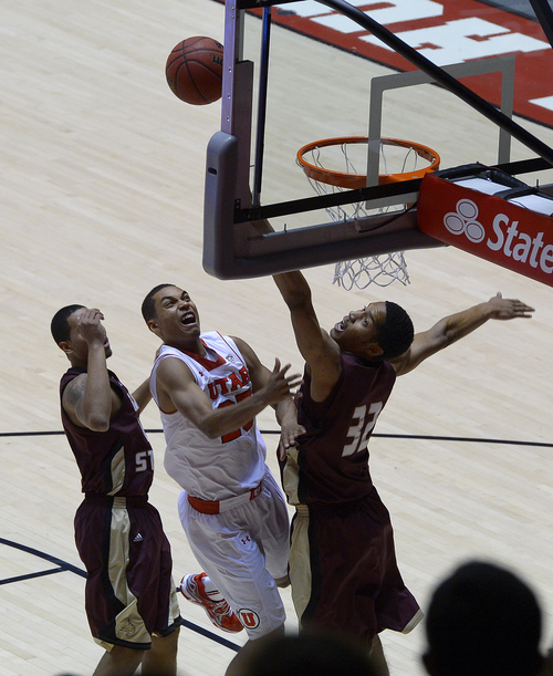 Scott Sommerdorf   |  The Salt Lake Tribune
The Utes' Kenneth Ogbe grimaces as he puts up a first half shot. Utah beat Texas State 69-50, Wednesday December 18, 2013.