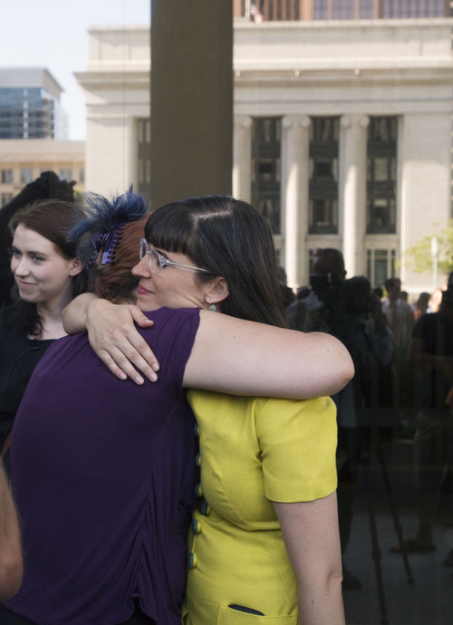 Steve Griffin  |  The Salt Lake Tribune

Kate Kelly, founder of Ordain Women, hugs a supporter outside the LDS Church Office Building in Salt Lake City, Utah Sunday, June 22, 2014, after saying "I will not be silenced" in front of hundreds of her supporters. She also placed her marriage certificate at the door. The event coincided with the church disciplinary court underway at Kate's former stake center in Virginia. Kate no longer lives in Virginia, and is living in Utah before she moves to Kenya with her husband.