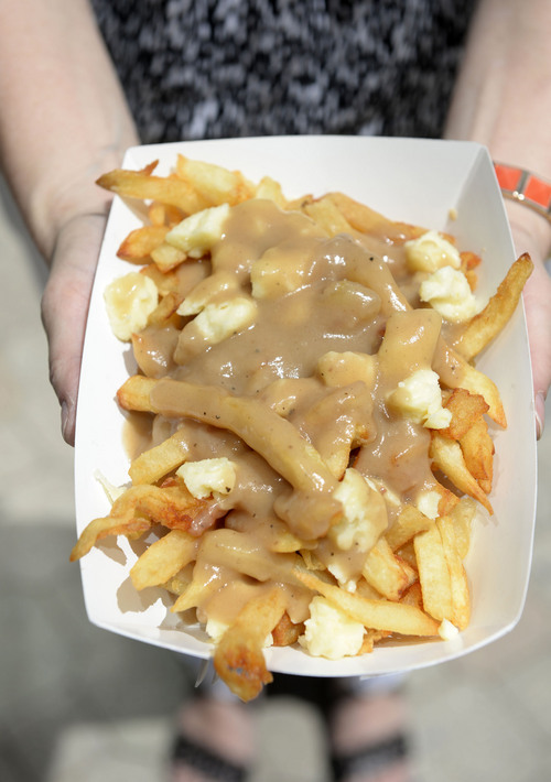 Al Hartmann  |  The Salt Lake Tribune
The "Traditional Poutine," hand-cut fries, cheese curds and signature brown gravy from the Gravy Train Poutinerie at the weekly food truck rally at Gallivan Center Thursday June 19.