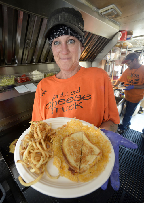 Al Hartmann  |  The Salt Lake Tribune
A combination order of a grilled cheese sandwich with fresh cut fries is ready to go on A Guy & His Wife Grilled Cheese Truck at the weekly food truck rally at the Gallivan Center Thursday June 19.