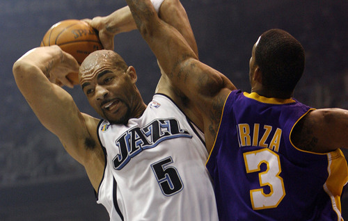 Utah Jazz forward Carlos Boozer (5)  pulls down a rebound under pressure from Los Angeles Lakers forward Trevor Ariza (3) during game 3 of the NBA playoffs at EnergySolutions Arena in Salt Lake City Utah Thursday, April 23, 2009.

Trent Nelson/The Salt Lake Tribune