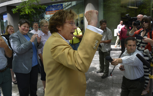 Scott Sommerdorf   |  The Salt Lake Tribune
Peggy Tomsic, lawyer for the three same sex couples who were plaintiffs in the 2013 lawsuit versus Utah, raises her fist as she celebrates the ruling outside her offices in Salt Lake City, Wednesday, June 25, 2014. Tomsic said: (the ruling) "affirms the fundamental principles of equality and fairness and the common humanity of gay and lesbian people."