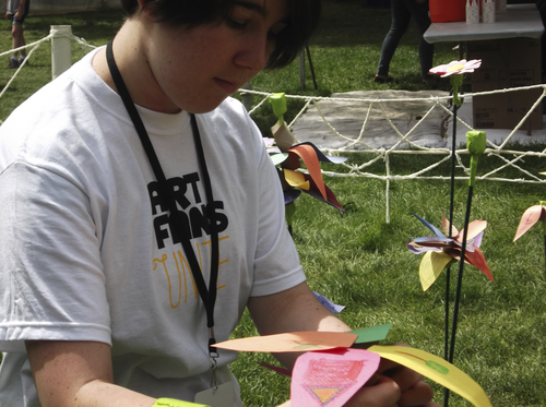 Sean P. Means  |  The Salt Lake Tribune

Emma Lynn of Orem, a staffer in the Art Yard at the Utah Film festivals, attaches a construction-paper flower to the Art Yard's "Grow a Garden" exhibit. Children create the flowers, for a constantly growing walkthrough garden.