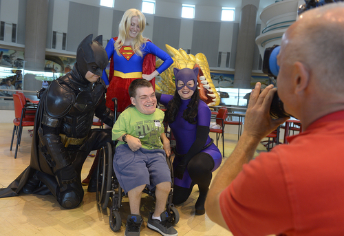 Scott Sommerdorf   |  The Salt Lake Tribune
Colton Purcell of Mapleton, center, has his moment with Batman (James C. Carlson), SuperWoman (Heidi Mason), and Catwoman (Melissa Powers) as costumed characters visited children at Shriner's Hospital, Thursday, June 25, 2014. The visit is in preparation for FantasyCon's "Night of Dreams" - a special preview event only July 2 for families associated with eight local charities that serve special needs and critically ill children.