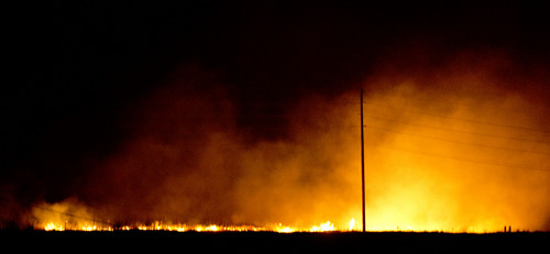 Jeremy Harmon  |  The Salt Lake Tribune

A fire burns just south of RioTinto's smelter near Magna in the early morning hours of June 26, 2014.